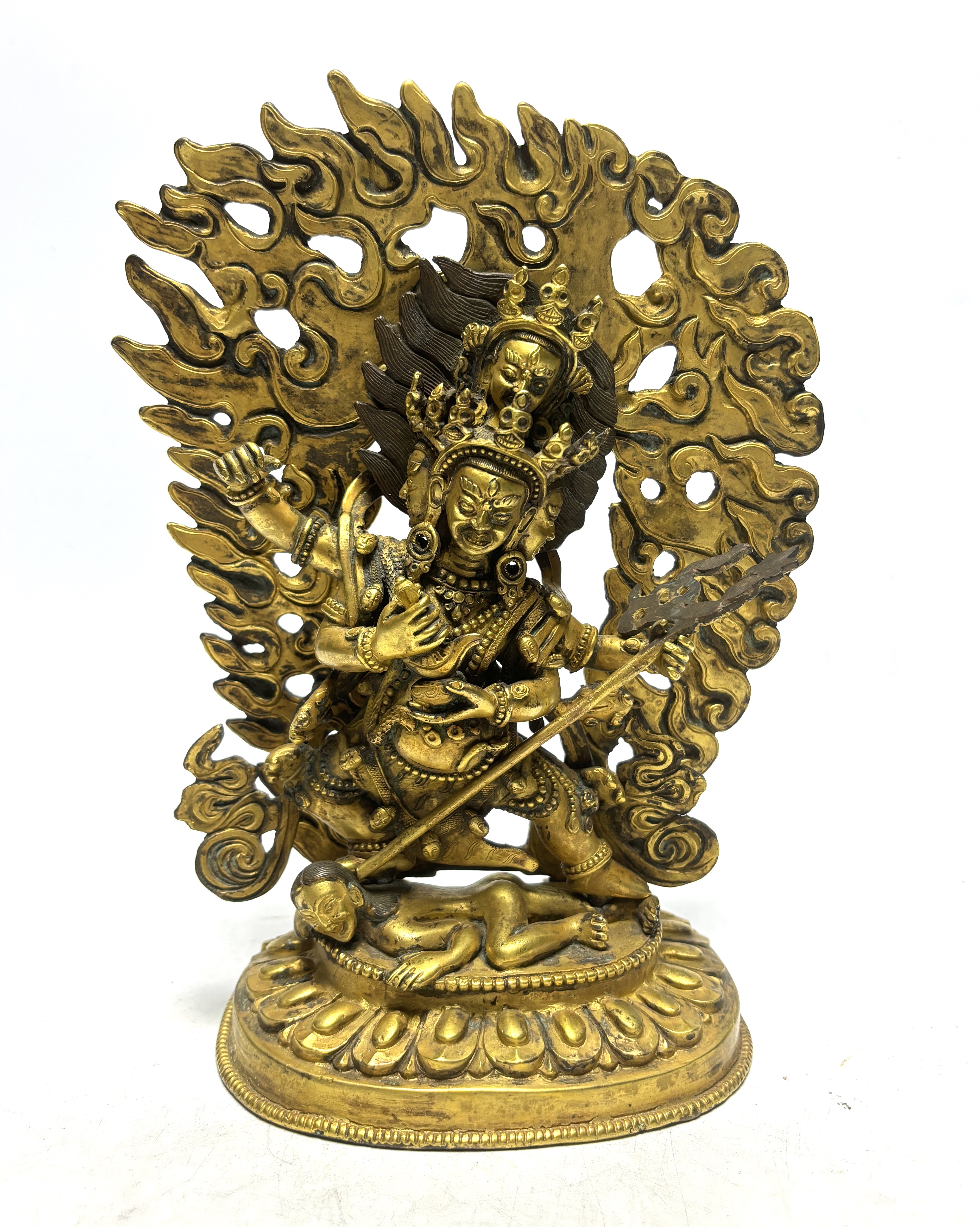 A Sino Tibetan gilt bronze figure of Mahakala, 23cm high